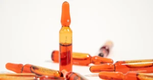 Ampoules of injectable solution arranged on a white surface, representing Vitamin B-12 in Yuma, Arizona.