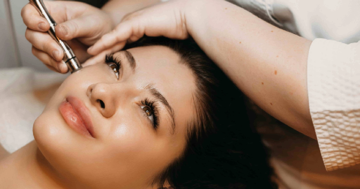 Young woman receiving a microdermabrasion facial treatment, relaxing with smooth glowing skin as a skincare professional gently works on her face in Yuma, AZ