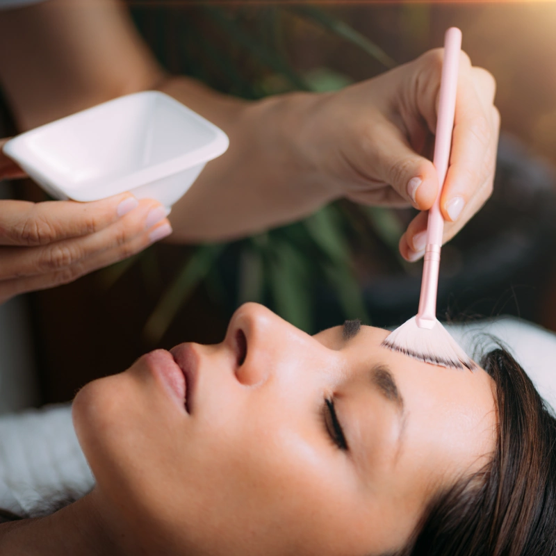 Aesthetician applying a chemical peel facial solution using a soft brush in Yuma, AZ | Amara Rejuve Medical Spa & Laser