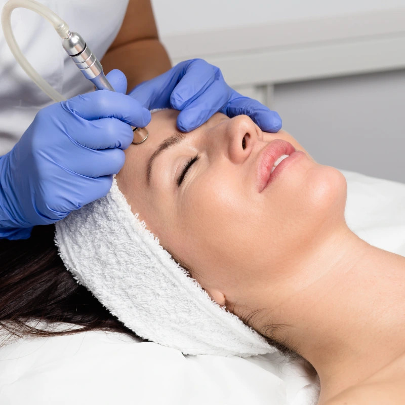 Aesthetician performing microdermabrasion treatment on patient forehead in Yuma, AZ | Amara Rejuve Medical Spa & Laser
